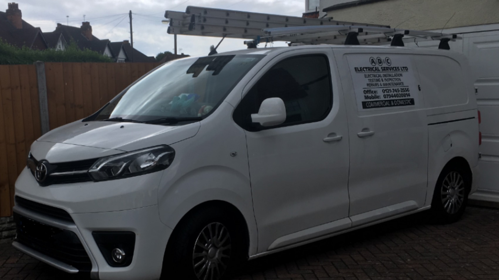 The van, outside a job. Commercial and domestic, installation, testing and inspection, repairs and maintenance — and the same mobile number that's on this website.